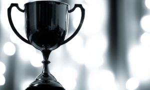 Close-up of Platinum Trophy with Handles on White Lights Background