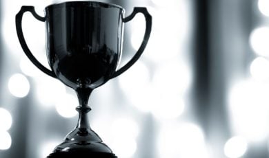 Close-up of Platinum Trophy with Handles on White Lights Background