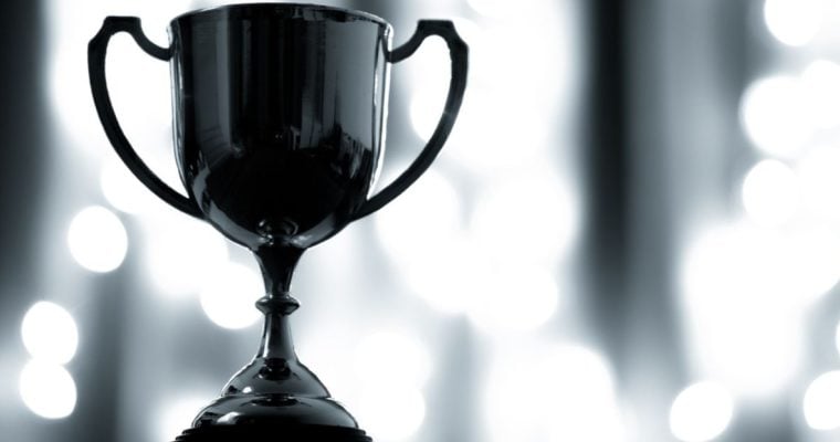 Close-up of Platinum Trophy with Handles on White Lights Background