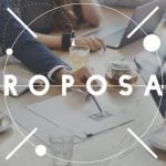 Team of Developers Sit at A Table Discussing Plans with Text Proposal Written Over Image