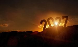 Sun Sets Behind Large 2027 Sitting On Top of Dark Mountain