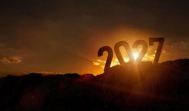 Sun Sets Behind Large 2027 Sitting On Top of Dark Mountain