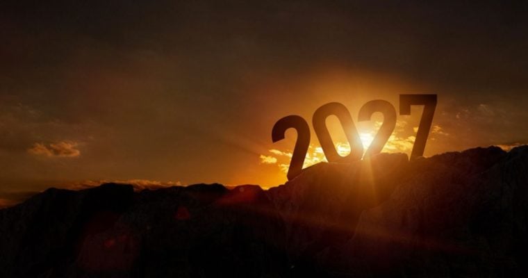 Sun Sets Behind Large 2027 Sitting On Top of Dark Mountain