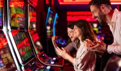 Three People Having Fun Inside Colorful Casino Slots Lounge