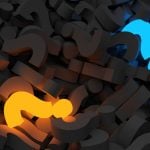 Glowing Yellow and Blue Question Marks Lay in a Pile of Charcoal-Colored Question Marks