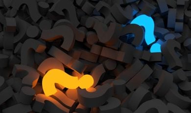 Glowing Yellow and Blue Question Marks Lay in a Pile of Charcoal-Colored Question Marks