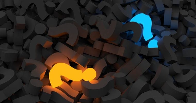 Glowing Yellow and Blue Question Marks Lay in a Pile of Charcoal-Colored Question Marks