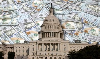 US State Capitol Building in Washington D.C., sits in Front of $100 Banknotes Laying on Flat Surface