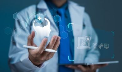 Man in Labcoat Stands Behhind Digital Icons Representing Mental Health and Online Support Services
