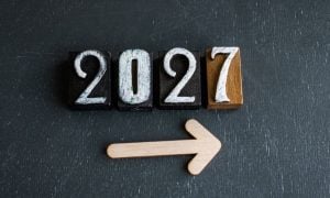 Wooden Blocks with 2027 in White Ink on Black Background with Arrow Pointing Right Below