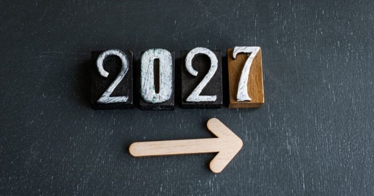 Wooden Blocks with 2027 in White Ink on Black Background with Arrow Pointing Right Below