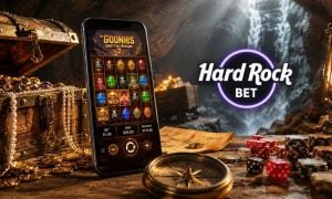 Cave Filled With Treasure, Cell Phone with Goonies Online Slot and Hard Rock Bet Logo