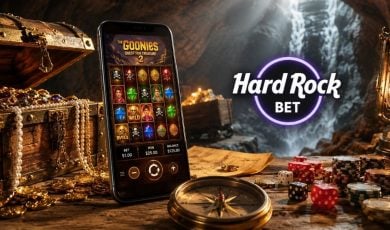 Cave Filled With Treasure, Cell Phone with Goonies Online Slot and Hard Rock Bet Logo
