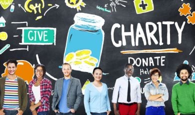 Blackboard with Sketch Images of Charity Donations and People Standing in Front