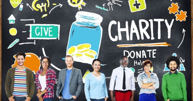 Blackboard with Sketch Images of Charity Donations and People Standing in Front