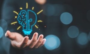 Lightbulb Brain Digital Illustration Floating in Man's Hand Represents Good Ideas