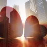 Double Exposure Image of Two Red Hearts On Cityscape Background