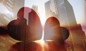Double Exposure Image of Two Red Hearts On Cityscape Background
