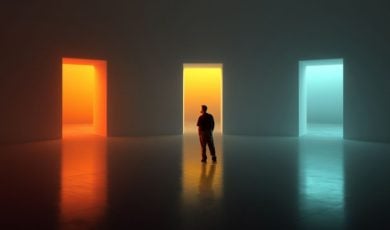 Man Stands In the Middle of Three Colorful Glowing Open Doors In Gray Room