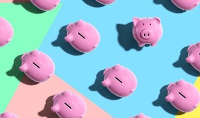 One Piggy Bank Faces Viewer While Others Face Left On Colored Flat Background