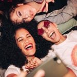 Three Gen Z Women Use Cell Phone to Take Selfie