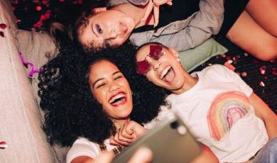 Three Gen Z Women Use Cell Phone to Take Selfie