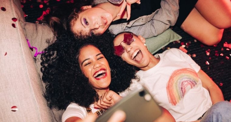 Three Gen Z Women Use Cell Phone to Take Selfie
