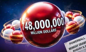 Red and White Lottery Balls Form Shape Like Planet Saturn with Powerball Lottery Ticket Announcing Tonight's Drawing