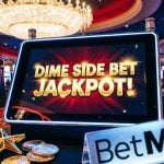 Brightly-Lit Slot Machines Inside Casino Background to Dime Side Bet Jackpot! Seen on Tablet