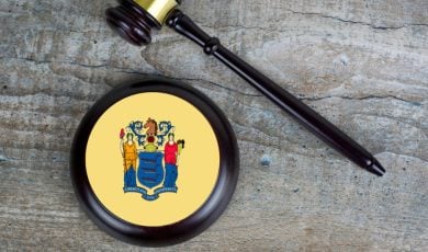 Judge's Gavel and Mallet with NJ State Flag Lay on Wood Background