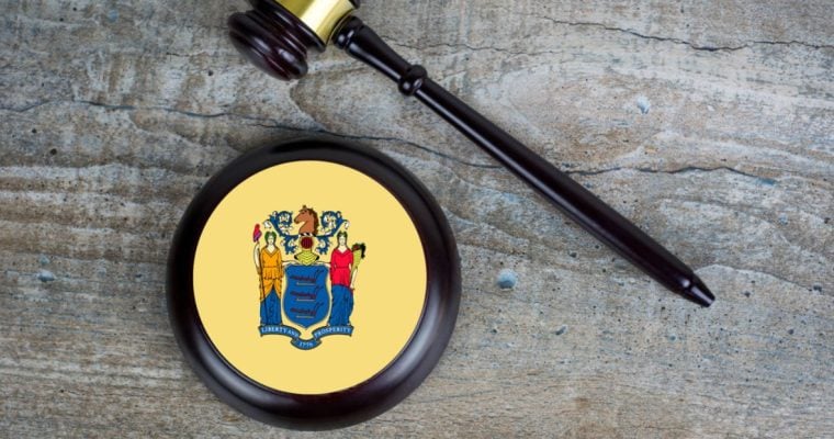 Judge's Gavel and Mallet with NJ State Flag Lay on Wood Background