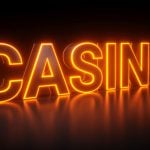 Bright Orange Neon Sign on Black Background Reads "Casino"