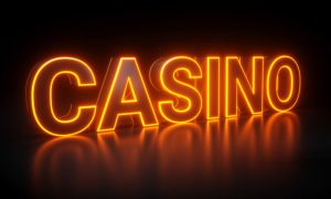 Bright Orange Neon Sign on Black Background Reads "Casino"