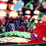 Flying Poker Chips and Stacks On Top of Casino Game Table