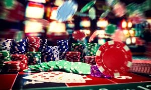 Flying Poker Chips and Stacks On Top of Casino Game Table
