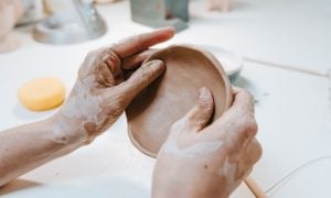 Clay Workshop With Woman Making Small Ceramic Plate