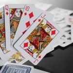Ace, King, Queen, Jack and 10 of Diamonds Stand Up on Black Table