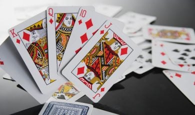 Ace, King, Queen, Jack and 10 of Diamonds Stand Up on Black Table