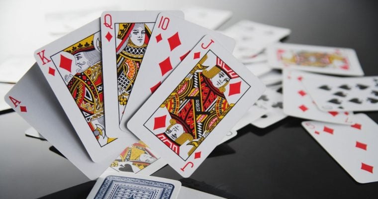 Ace, King, Queen, Jack and 10 of Diamonds Stand Up on Black Table