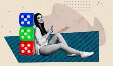 Woman Holding Cell Phone Sits Leaning Against 3 Blue, Green and Red Dice