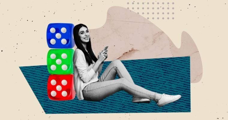 Woman Holding Cell Phone Sits Leaning Against 3 Blue, Green and Red Dice