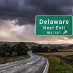 Storm Clouds and Delaware Exit Sign Over Country Road