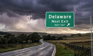 Storm Clouds and Delaware Exit Sign Over Country Road