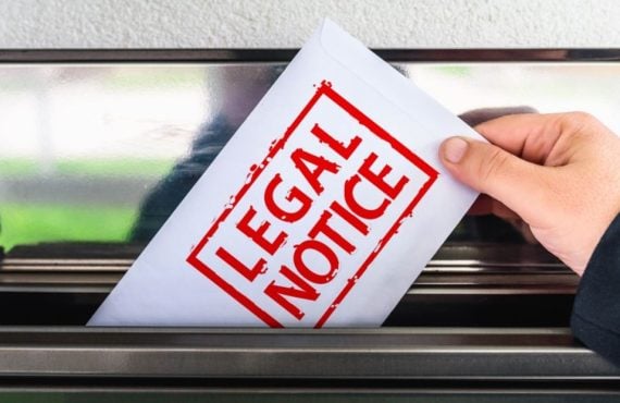 White Envelope with Red Letters Read Legal Notice Pulled Out of Mailbox