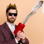 Attractive Man in Suit Uses Cash Dispenser To Shoot Money in Air