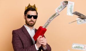 Attractive Man in Suit Uses Cash Dispenser To Shoot Money in Air