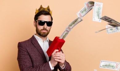 Attractive Man in Suit Uses Cash Dispenser To Shoot Money in Air