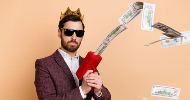 Attractive Man in Suit Uses Cash Dispenser To Shoot Money in Air