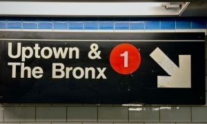Subway Sign in NYC Reads Uptown & The Bronx with 1 in Red Circle