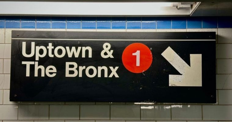 Subway Sign in NYC Reads Uptown & The Bronx with 1 in Red Circle